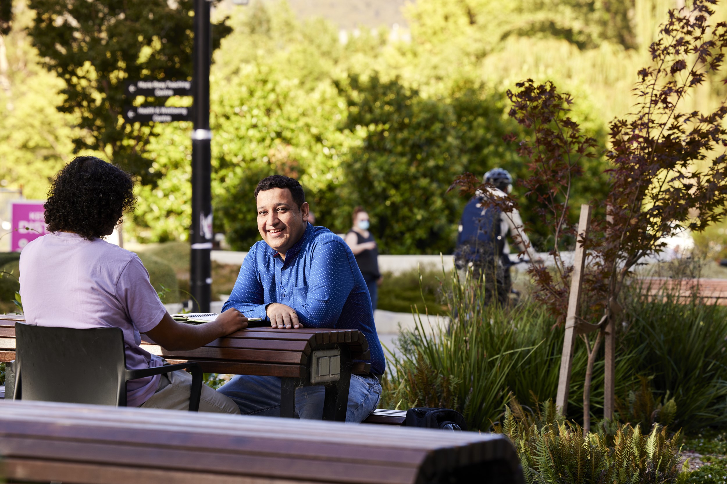 Two people sitting outside