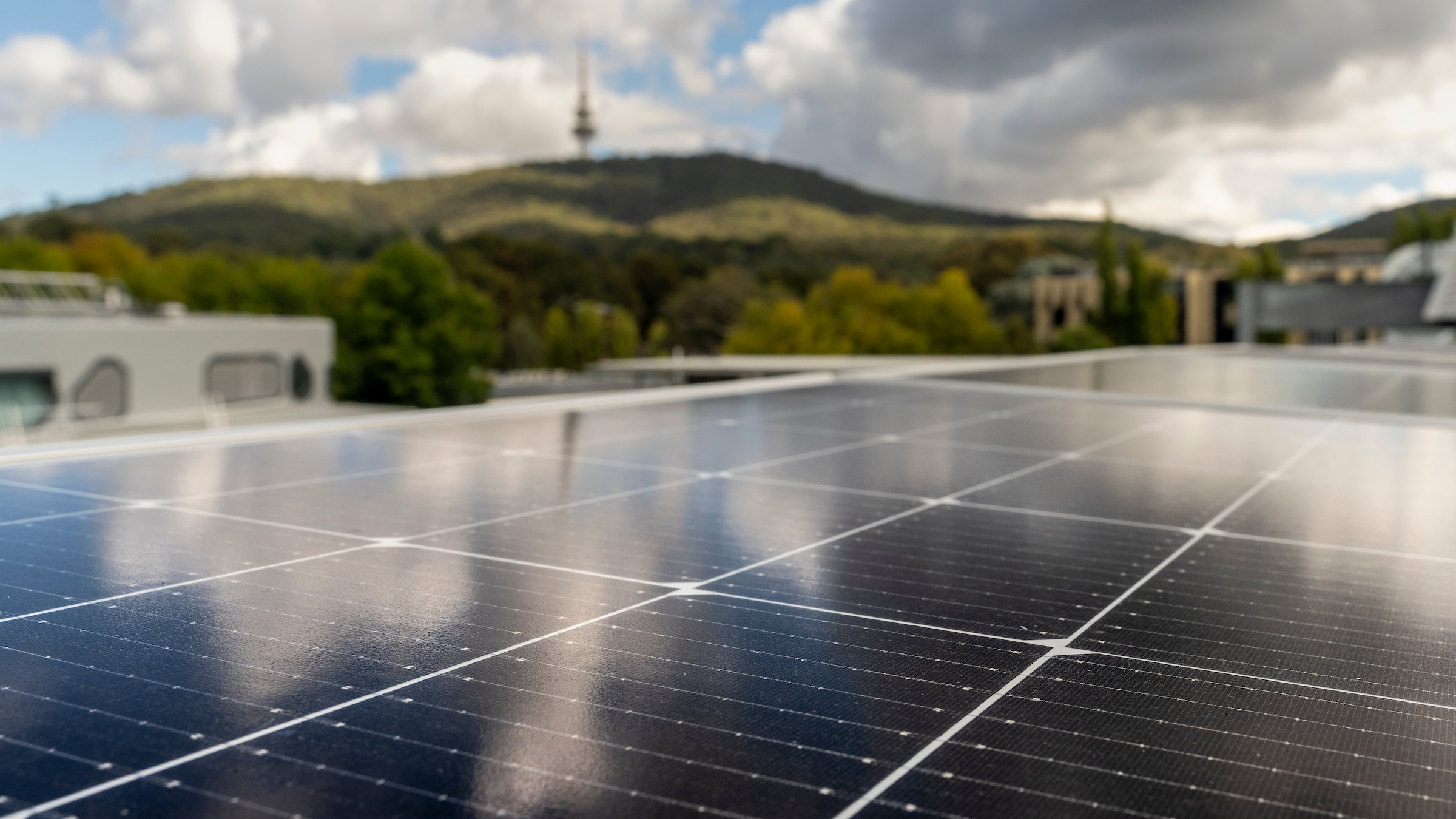 Image of solar PV on rooftop looking out at Black Mountain in the background