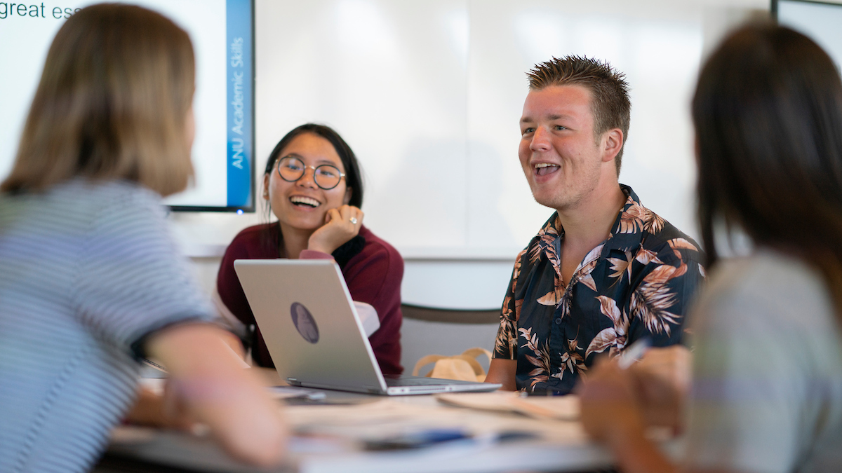 Image of four students at desk