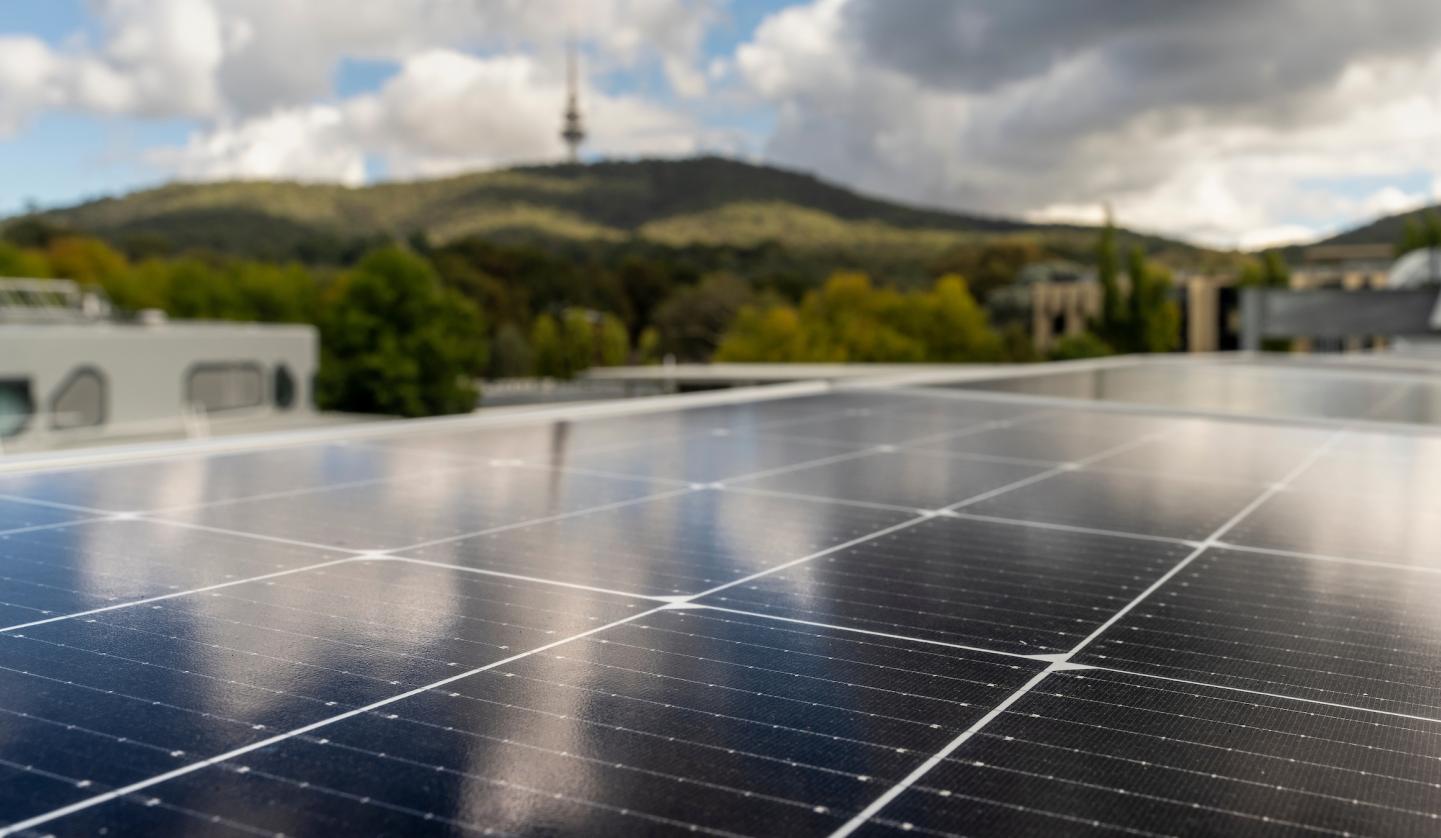 Image of solar PV on rooftop looking out at Black Mountain in the background