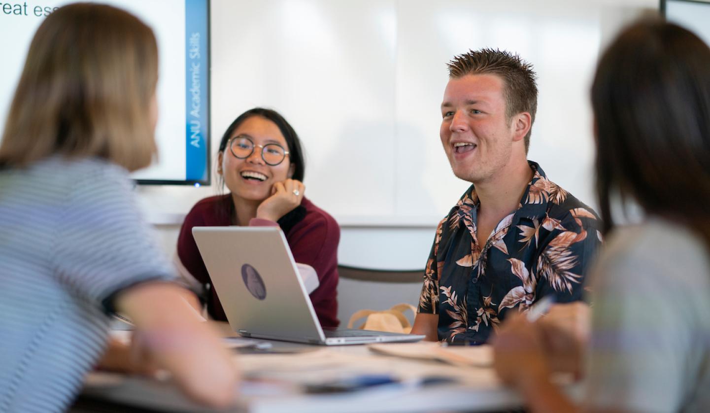 Image of four students at desk