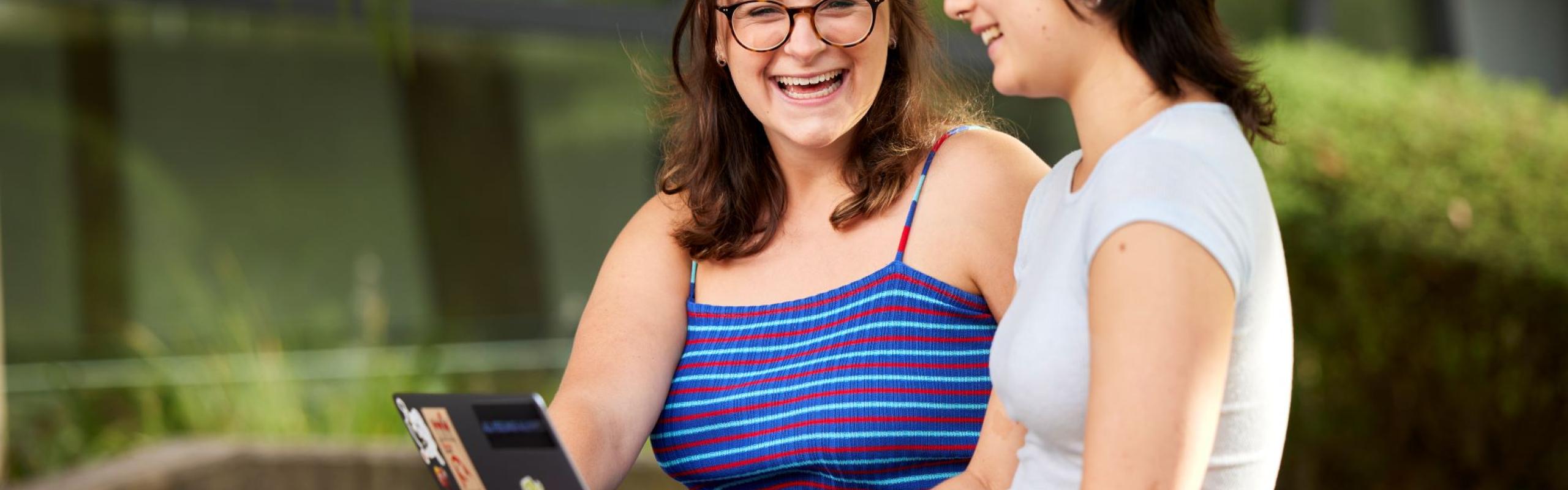 Image of two people at laptop