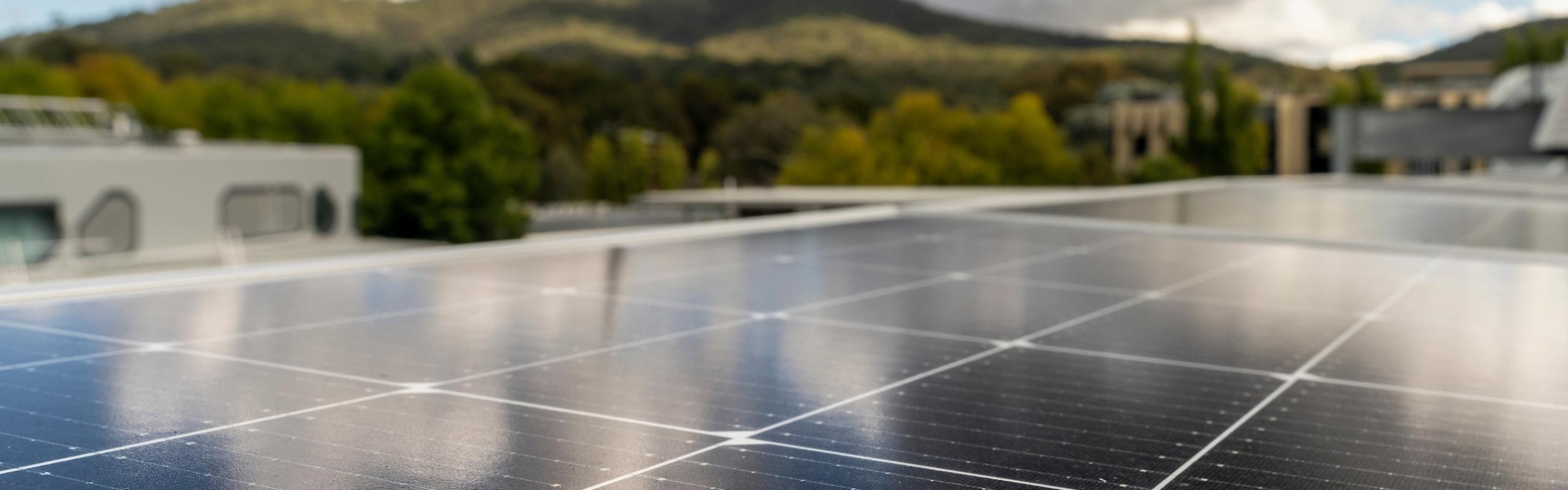 Image of solar PV on rooftop looking out at Black Mountain in the background